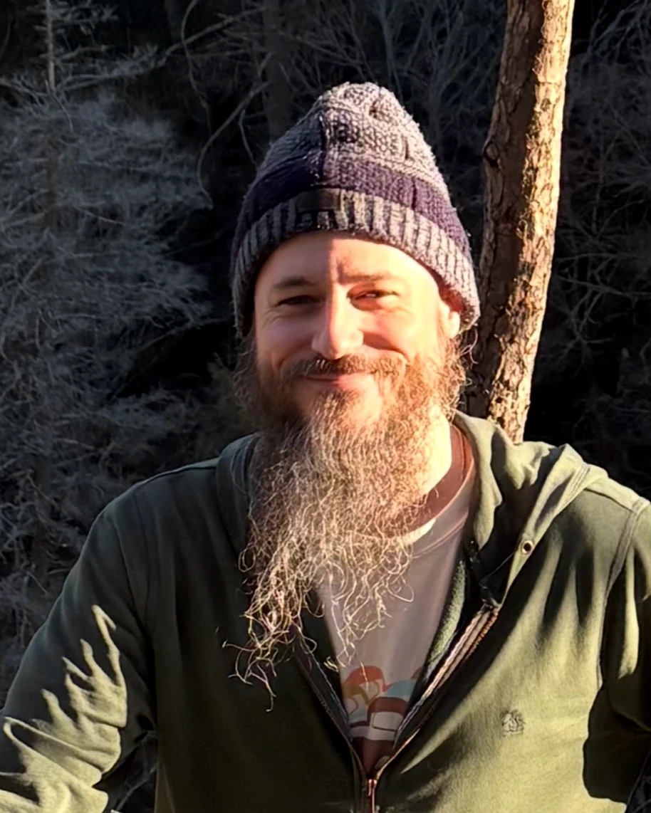Evans, the tabletop RPG educator behind Next Level RPG, smiling outdoors